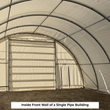Inside front wall of a single pipe building, roll-up winch door and fabric man door