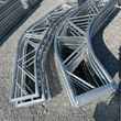 Galvanized dual-truss arch frame sections stacked flat, example frame from a 50x100 model