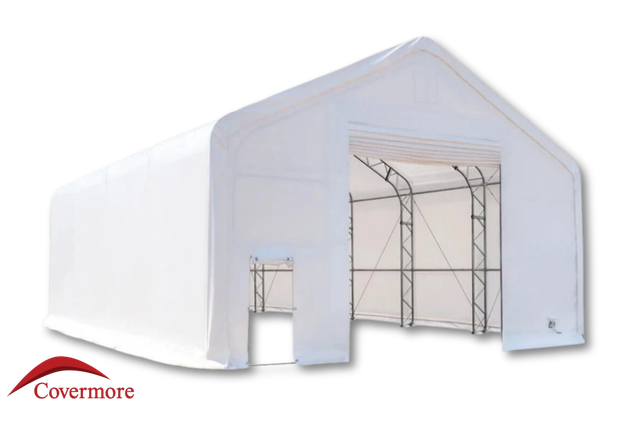 White 30oz PVC dual-truss fabric building, open end wall showing galvanized steel truss arches and a man door