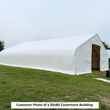 Customer photo of a large white fabric building on grass with the end door open