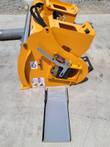 Yellow concrete mixer's dual discharge: hinged upper gate, fold-down lower chute and hydraulic hoses