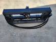 Arteer 3-point hitch adapter frame, hydraulic drive unit centered on the crossbar, two hoses coiled below