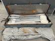 Front wall kit crated: galvanized poles and rope in a steel box beside the folded cover bundle