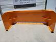 Snow plow blade straight on: orange moldboard, ribbed supports and a white poly cutting edge