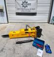 Yellow TOFT750 breaker in profile with black bracket, spare chisel, blue tool box and nitrogen charging kit