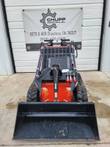 AGT LRT23 mini skid steer, red machine facing forward with black bucket lowered on rubber tracks
