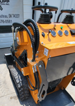 QB-480 mini skid steer hydraulic hose routing and quick-connect couplers above the rubber track