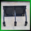 Black three-tine ripper attachment, front view, quick-attach plate above three curved tines and feet
