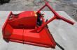 Red disc mulcher from above: sloped housing, twin hydraulic hoses with couplers and the steel push frame