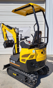 FF15 mini excavator, rear three-quarter: yellow canopy over the seat, vented engine cover, boom folded with the bucket