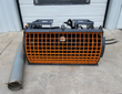 Arteer concrete mixer: cylindrical mixing drum behind an orange mesh guard, gray discharge chute and quick-attach mount