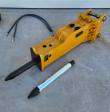 Yellow SB45 hydraulic breaker with mounting bracket and pins, moil chisel fitted, spare chisel and coiled hoses