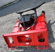 Red disc mulcher from the rear: black quick-attach mount plate, hydraulic motor and hoses, GIYI badge