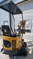 AGT H12R mini excavator operator station: seat under the canopy, joysticks and hand levers, vented engine cowl