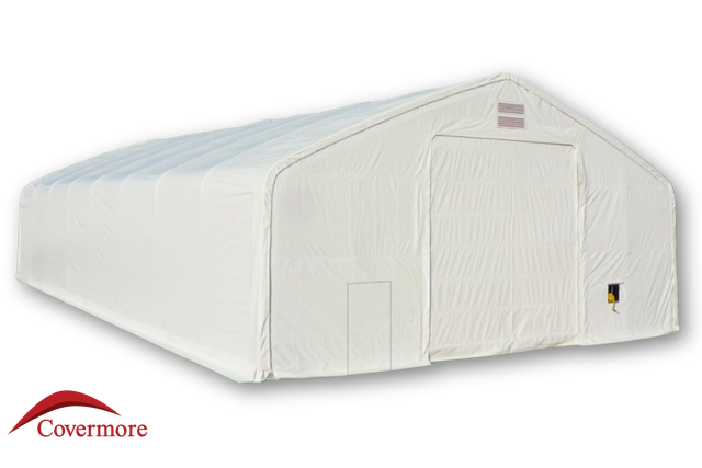 White 30oz PVC dual-truss fabric building, front end wall with large winch door, man door, and two peak vents