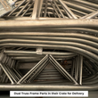 Dual-truss frame tubing and steel connector plates crated for delivery
