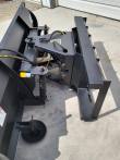 Push blade angle adjustment: dual hydraulic cylinders with coil springs and a manual hand crank