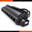 Wolverine vibratory roller attachment: black drum, hydraulic motor and coiled hoses at the skid steer mount