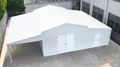 White 42x30 steel garage assembled, ribbed metal roof, open lean-to bay, double doors and side walk door