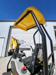 FF15 operator station: yellow canopy on the black ROPS frame above the seat, joysticks, armrest and red lock lever