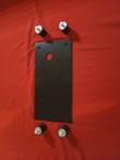 Black steel engine mounting plate with bolt holes laid flat beside four rubber anti-vibration mounts with studs and nuts