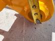 Tape measure between two pin holes on the rake's yellow mounting frame, documenting hole spacing
