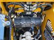 AGT CRT23 hydraulics: stacked control valve bank feeding braided hoses over the shielded muffler and exhaust