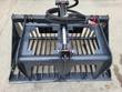 44-inch rock grapple, clamp arm closed across spaced steel tines with the hydraulic cylinder at center