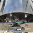 GIYI vibratory roller drum end: bolted hub flange, pillow block bearing and wrapped hydraulic hoses to the drive motor