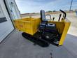 Yellow tracked mini dumper, side view with operator seat, control levers, 420cc engine and rubber tracks