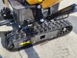 Rubber track and drive sprocket on the AGT H12R mini excavator undercarriage, with the blade cylinder above