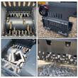 WIG asphalt block crusher detail set: carbide-tooth rotor, quick-attach plate, concrete block in the hopper