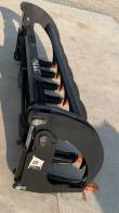 78-inch rock grapple bucket from above, grapple arms open, hydraulic cylinder and orange tooth tips