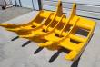 Yellow TOFT10R excavator rake, five curved tines with bolted tips and twin pin-boss mounting arms