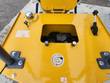 DM12-C rear deck: chrome hydraulic fill cap, recessed gasoline fill cap with the refueling decal, and the throttle lever
