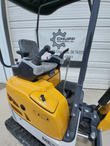 ME20 mini excavator operator station: twin pilot joysticks, key in the ignition, seat and floor pedals under the canopy