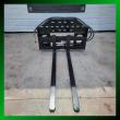 60-inch pallet forks straight on inside a green photo border, forks extended, hoses over the backrest