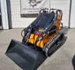 Orange ATS-T460 mini skid steer with bucket attachment, tracked undercarriage