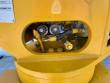 Hydraulic valve block and fittings inside the grapple head's oval cutout, above the rotator bearing