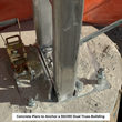 Galvanized steel frame legs anchored to concrete piers with cable turnbuckles