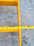 Tape measure across the yellow rake's frame, scale reading past 46 inches