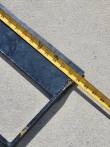 Tape measure along the land leveler's steel side rail, reading about 39 inches at the end weld