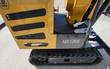 MX12RX model decal on the mini excavator frame, beside the vented side panel, travel pedals and rubber track