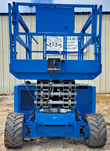 Blue Genie GS-3369RT rough-terrain scissor lift, rear view, engine cover and knobby tires
