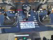ATS-T460 mini skid steer operator controls: twin steering levers, center auxiliary hydraulic lever and control decal