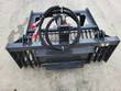 Back of the Landhonor rock grapple, mini skid steer mount plate, red-capped couplers and the spec plate