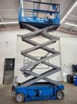 Genie GS-2632 scissor lift fully raised, scissor stack extended indoors