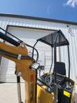 AGT H12R mini excavator boom with LED work light and hydraulic lines, beside the black canopy and seat