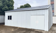 White 28x25 metal workshop assembled, dark ribbed roof, double doors and sliding end window