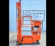 Orange Ballymore push-around lift, mast lowered, steel platform with guardrails and swivel casters